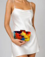 Izoa Cosima Abstract Acrylic Clutch in Multi – worn by a model