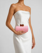 Izoa Margaux Woven Clutch in Pink – worn by a model