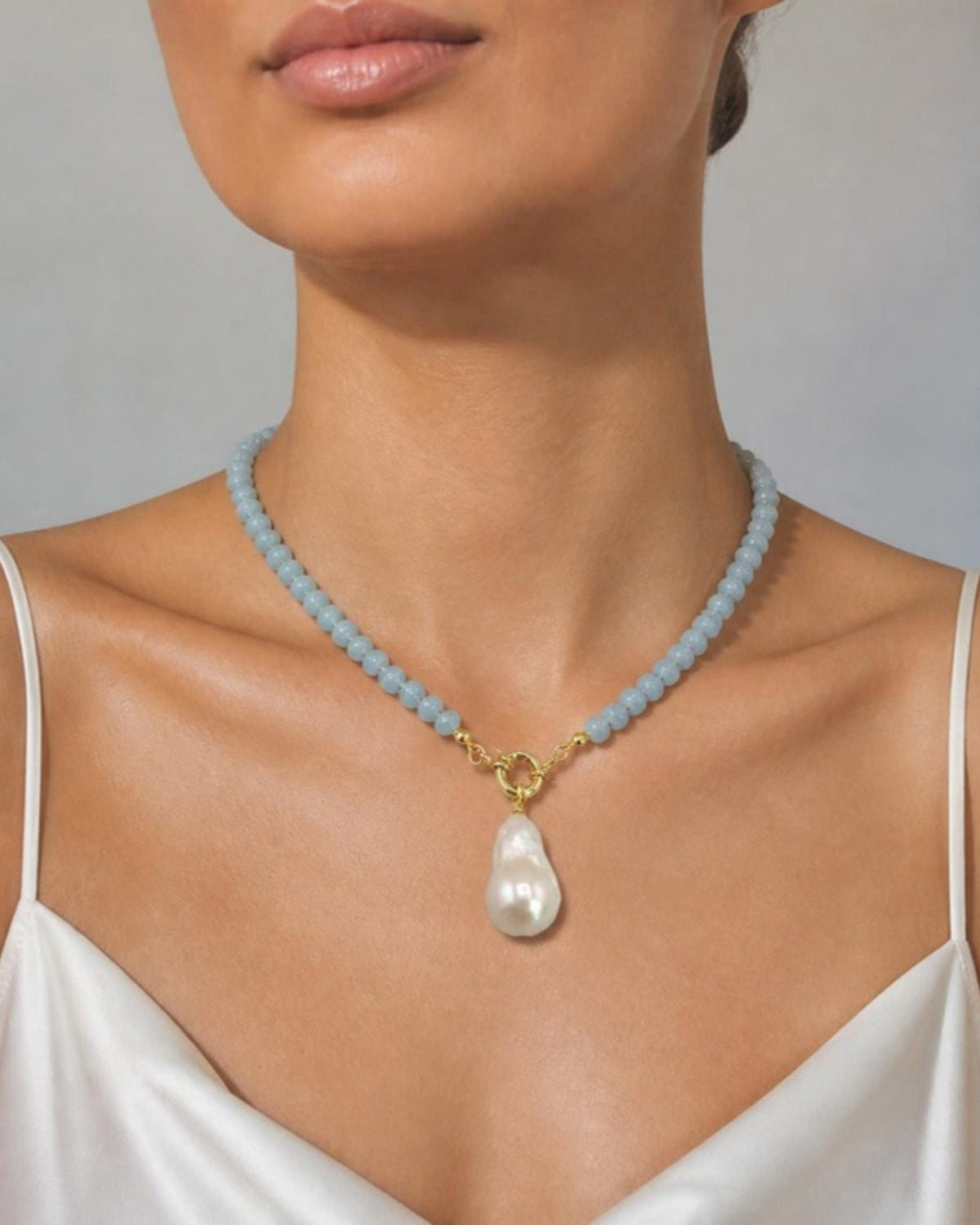 Izoa Philippa Baroque Pearl Drop Necklace in Blue – worn by a model
