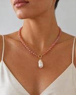 Izoa Philippa Baroque Pearl Drop Necklace in Peach – worn by a model