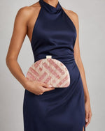 Izoa Rosalind Half Moon Clutch in Pink – worn by a model